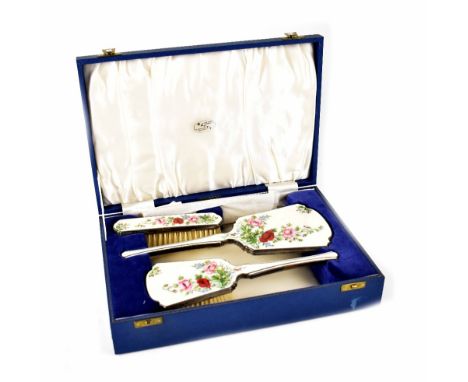 An Elizabeth II Art Deco style hallmarked silver and engine turned enamel four-piece dressing table set comprising hand mirro