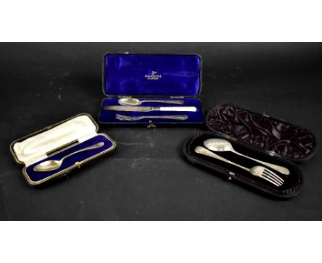 Three cased hallmarked silver Christening sets, one three-piece comprising knife, fork and spoon, Walker &amp; Hall, one comp