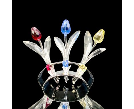 A set of crystal figures consisting of 3 tulips, red, blue, and yellow and their stand. There are 9 mini tulips of red, blue,