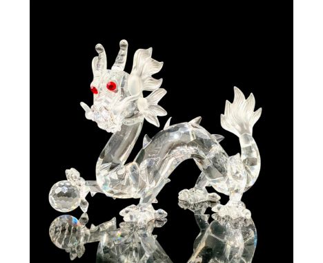 A clear and frosted crystal figure that depicts a serpent dragon with red eyes standing on all four of his legs. Includes bla