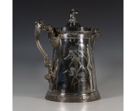 Imposing Victorian style silverplate insulated pitcher with a Cupid holding a goblet set on the top of the lid. The body is i