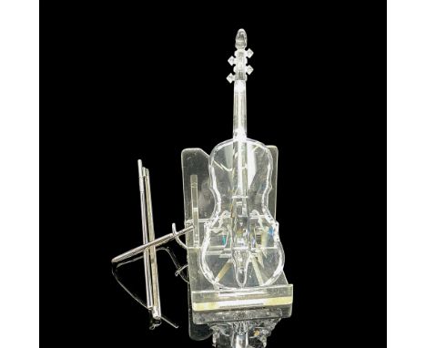 Designed in clear crystal with shiny chrome bow stand. Swarovski backstamp. This item has its original box: 6"H x 3"dia. Cert