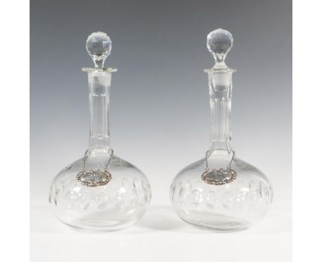 Matching set of decanters with sterling silver tags labeled scotch and rye. The tags are marked sterling on the back and weig