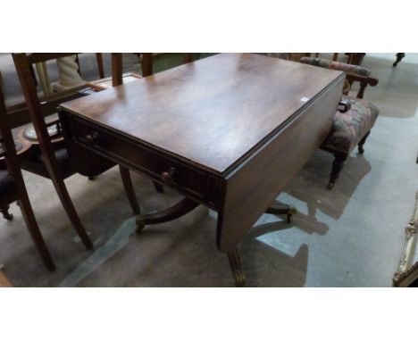 A George IV mahogany sofa table with one real and one dummy drawer, raised on quadripartite down swept support. 42'' wide