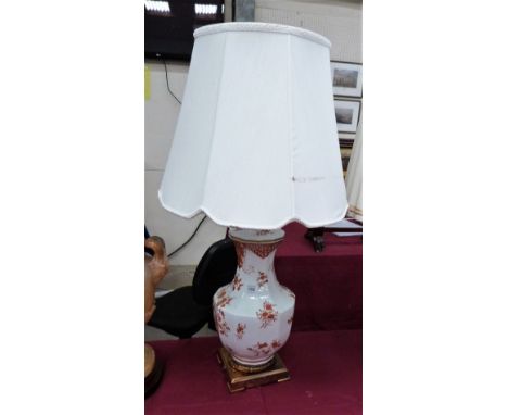 A ceramic and gilt brass based table lamp, decorated in iron red with foliage. The base 18'' high