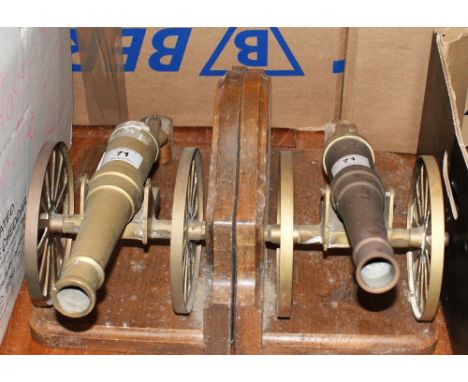 A pair of brass cannon bookends