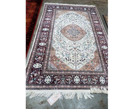 A cream ground eastern carpet 82'' x 53''