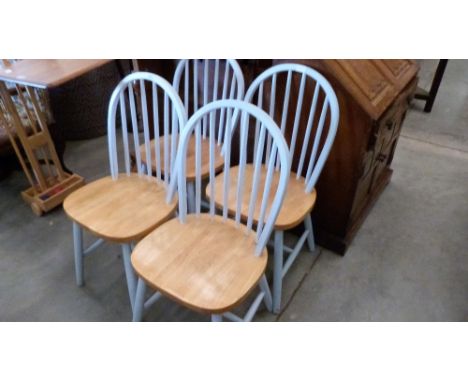 A set of four stick back kitchen chairs