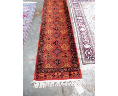A red ground Shiraz carpet runner 100'' x 26''