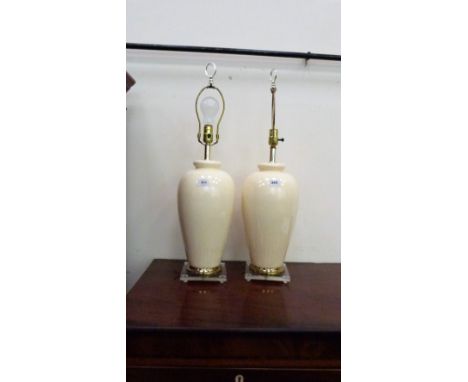 A pair of ceramic based table lamps