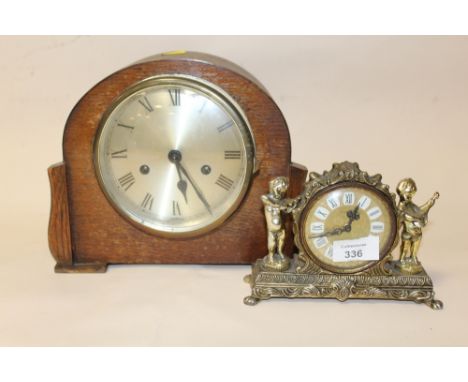 A SMALL GILT METAL DESK CLOCK TOGETHER WITH AN OAK MANTEL CLOCK