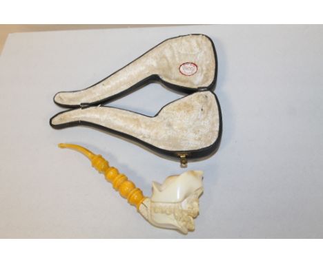A CASED CARVED MEERSHAM STYLE PIPE WITH AMBER STYLE CHEROOT, CRACKED BY JOIN