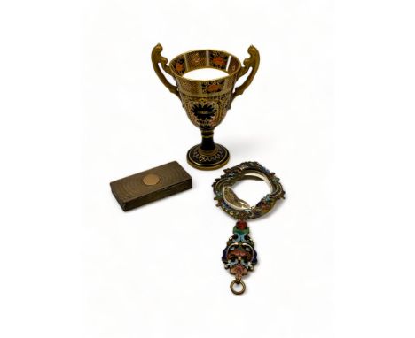 A Victorian champlev&eacute; enamel hand mirror, a silver snuff box and a Crown Derby urn
The mirror of asymmetric shape with