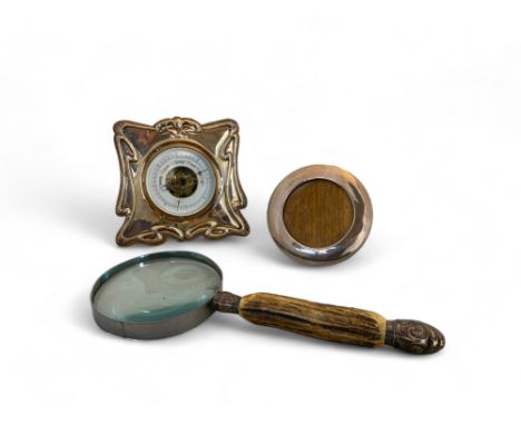 An Art Nouveau silver desk barometer, John Gilbert, Birmingham, 1904, a silver circular photograph frame, London 1919 and a s