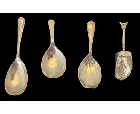 A group of four silver caddy spoons
Comprising of a foliate engraved caddy scoop, Birmingham 1876, two plain oval bowl spoons