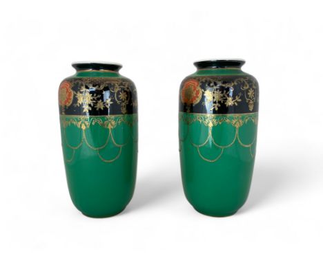 A pair of early 20th century Japanese Noritake vases Heightened with gilt decorated with flowers with orange reserves and bla
