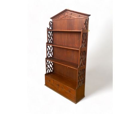 A George III style mahogany hanging shelf in the Chippendale style
The architectural blind fret pediment above four graduated