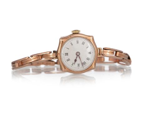 NINE CARAT GOLD MANUAL WIND WRIST WATCH, the round dial with Roman hour markers, 21mm case, on an expanding bracelet marked 9