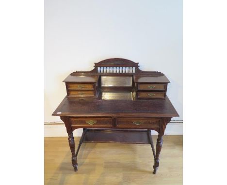 A late Victorian / Edwardian mahogany mirror back desk with 4 small upstand drawers above a leather top and two frieze drawer