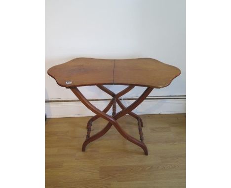 A walnut folding coaching table with a shaped top, 69cm tall x 90cm x 44cm, good light colour and patina 