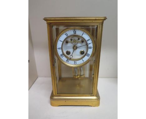 A gilt brass 4 glass mantle clock with exposed escapement, 25cm tall x 15cm wide, in running order, glass good 