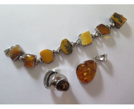 A silver amber ring, pendant and bracelet 
