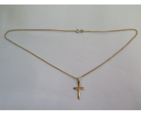 A 14ct yellow gold crucifix on a 9ct 46cm chain, total weight approx 3.5 grams 