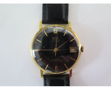 An 18ct yellow gold manual wind gents Britix wristwatch with date, black dial, 33mm case, total weight approx 28 grams, runni