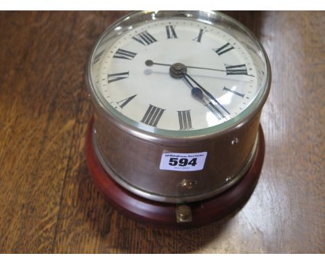 A G.P.O wall clock on a wooden boss, case 13cm diameter, 11cm tall, marked G.P.O C G 26 235 No1, in running order, some crack