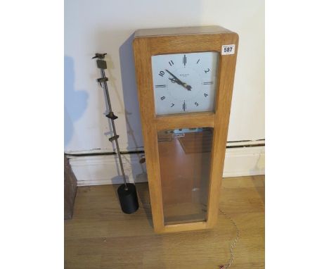 A 20th century oak cased Magenta electric master clock, 73cm tall 
