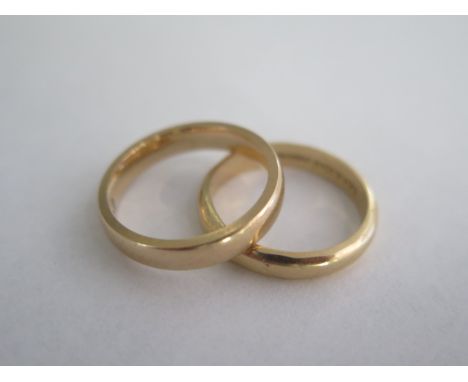 A 9ct yellow gold band ring, size L/M, approx 4 grams, and a 14ct band ring, size M/N, approx 3.3 grams 