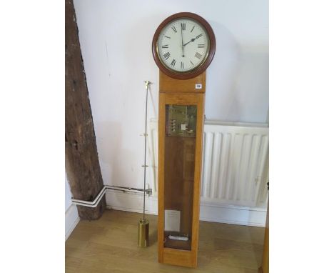 An oak cased electric master clock with 10" dial - Height 145cm