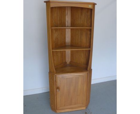 An Ercol elm corner cabinet with a single door - Height 160cm - as new 