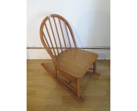 An Ercol Blonde Elm child's rocking chair with sliding box - Height 72cm 