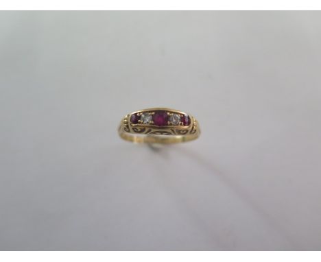 A ruby and diamond half hoop ring - cast scrolled shoulders and bezel set with three mixed cut rubies and two old cut diamond
