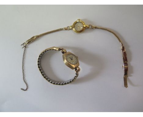 An 18ct yellow gold manual wind ladies watch on a 9ct strap, total approx 13.7 grams, and a 9ct watch on a plated sprung stra