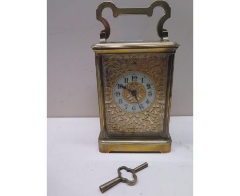 A good quality 8 day French carriage clock striking hours and half hours, dial with pierced brass surround, in working order,