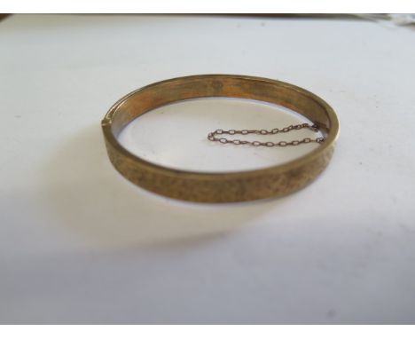 A 9ct yellow gold hollow bangle - 6.5cm x 5.5cm - approx weight 9.5 grams - generally good condition 
