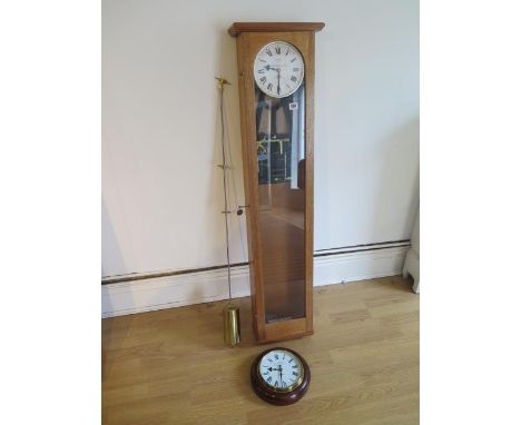 A 20th century oak cased synchronome electric master clock John Draper and Son St Neots Huntingdonshire, 127cm tall with a sy