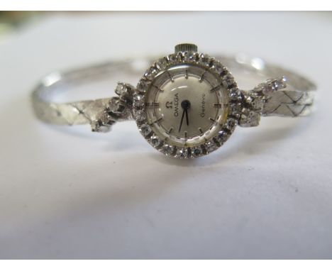 An Omega 18ct white gold diamond set ladies manual wind bracelet cocktail watch, 17mm case, in running order, good condition 