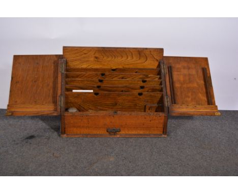 Edwardian oak slope front desk stand, two hinged doors enclosing a stationery rack, single drawer under, width 39cm.