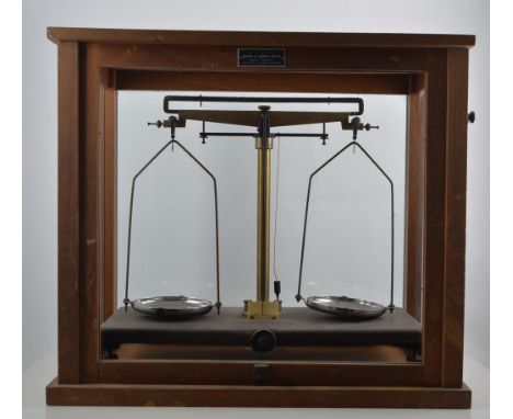 Set of Pharmaceutical beam balance scales, by Griffin & George Limited, Bakelite platform, glazed case, width 46cm.