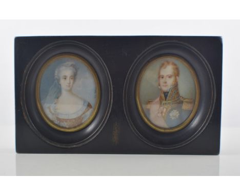 After Nettier, a pair of oval portrait miniatures in a single ebonised frame, 10cm x 17cm.