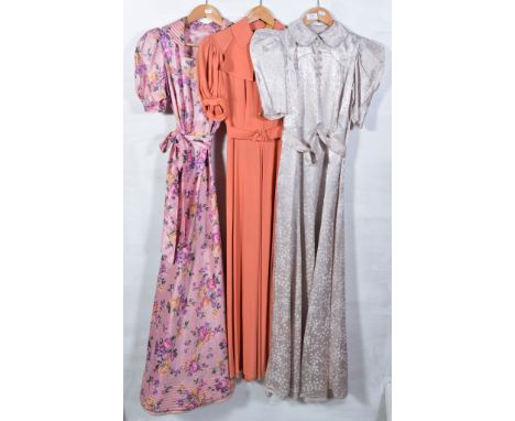 Three 1930's 1940's long afternoon dresses, a salmon pink crepe button top dress with puff sleeves and machine detail to coll