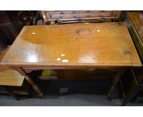 Late Victorian oak card table, rectangular fold over top with a moulded edge enclosing a baize lined interior, carved frieze,