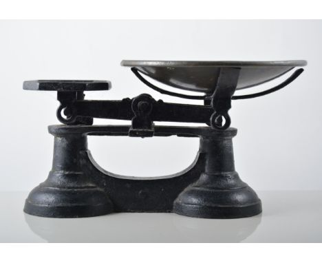Set of cast iron balance scales, with weights.