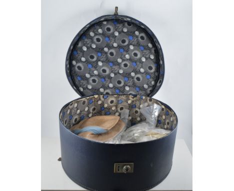 Navy blue vinyl hat box containing vintage white cotton stockings, Victorian lace cuff gloves, pink kid gloves, evening glove