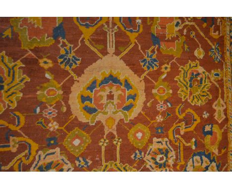 Turkey carpet, cut and lacking end, pattern field, border within guards, 320cm x 280cm.