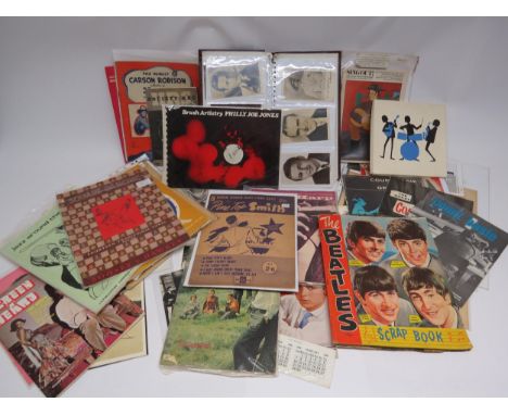 A collection of assorted film and music ephemera including film star photocards, Beatles scrapbook with clippings, handkerchi