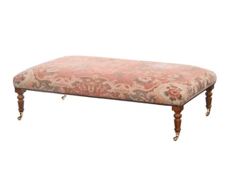 A late 20th century reproduction lounge stool, of large proportions with turned mahogany legs and floral tapestry upholstery.